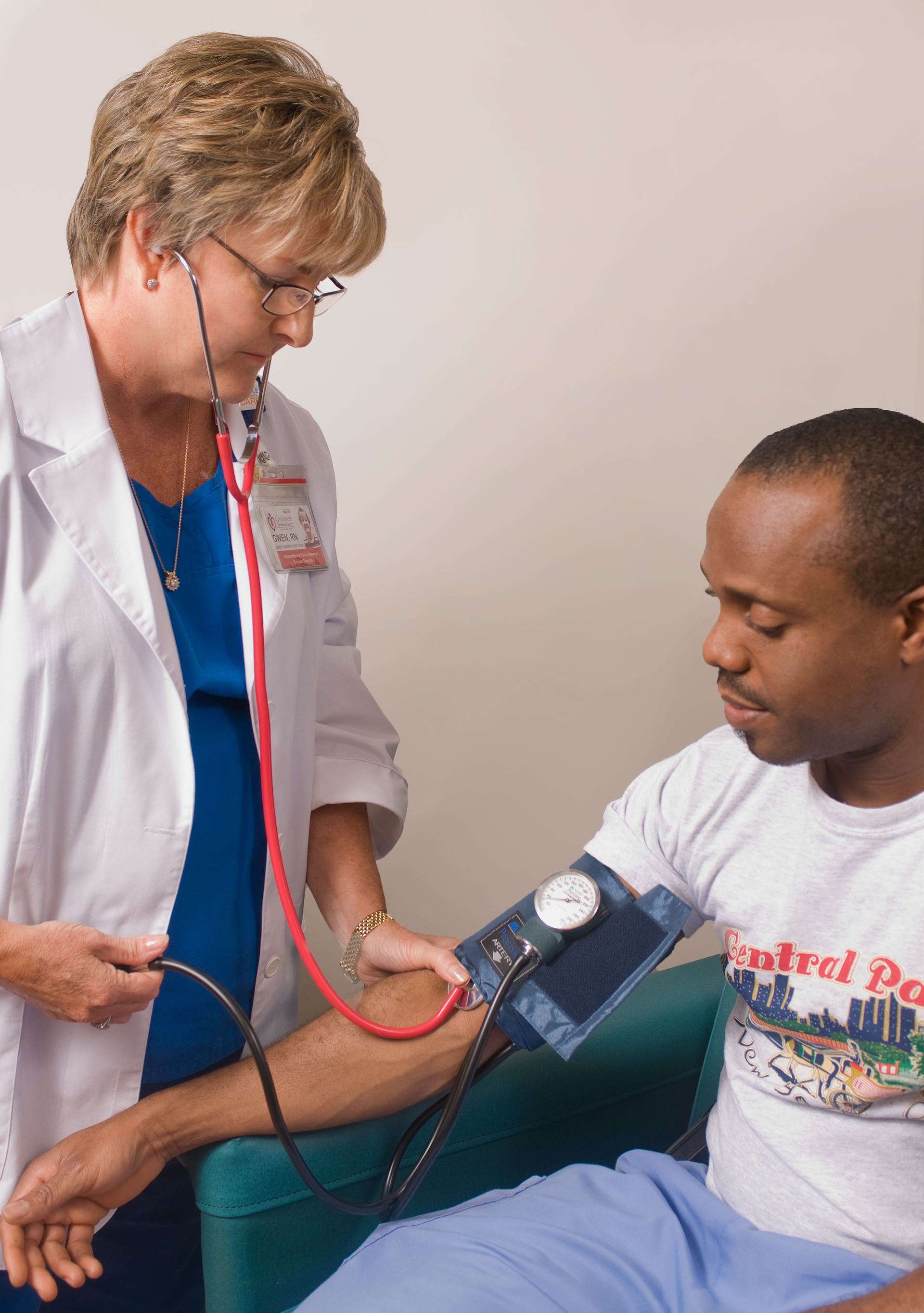 Doctor taking patient blood pressure