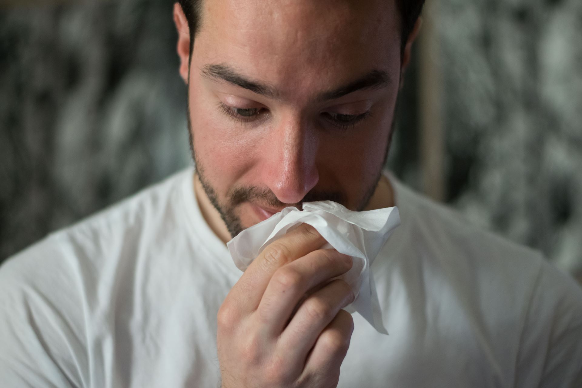 Man with a tissue over his face